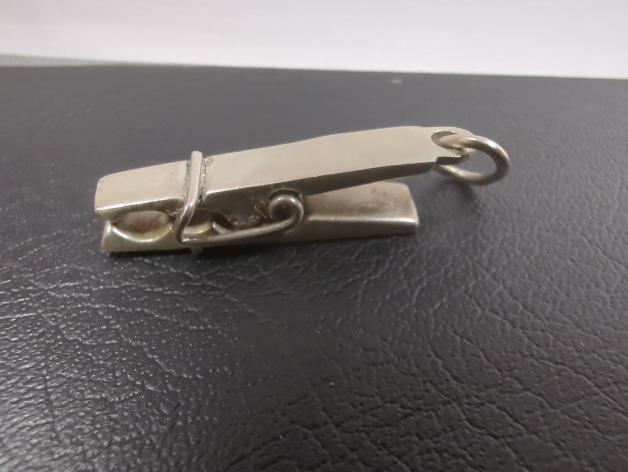An Edwardian silver miniature model of an occasional chair, import marks for London, 1902, 43mm, a continental white metal model of a shoe and a similar model of a young child, a base metal 'book' box containing a rosary